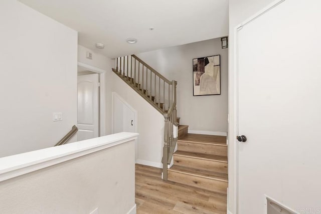 stairway with hardwood / wood-style flooring