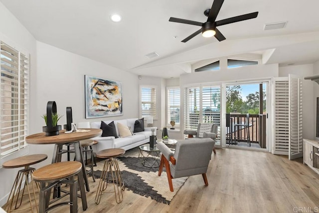 living room with vaulted ceiling, ceiling fan, and light hardwood / wood-style flooring