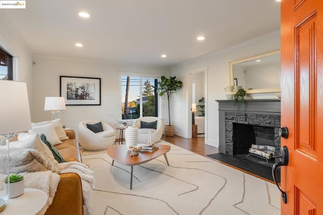 living room featuring ornamental molding, dark wood-type flooring, and a fireplace