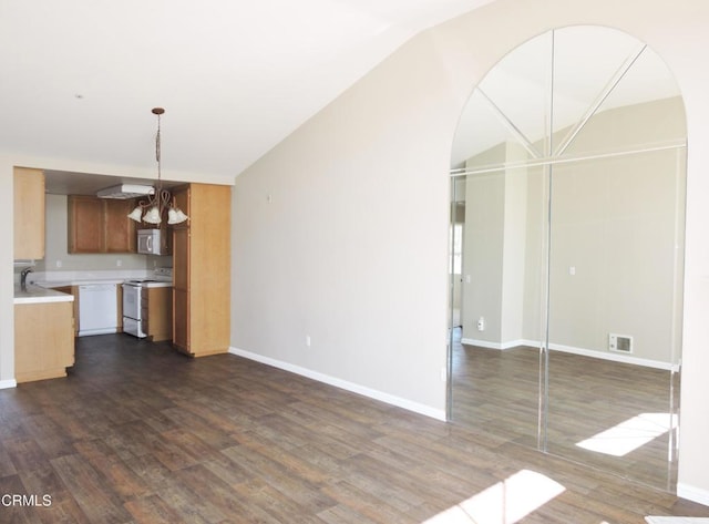 unfurnished living room featuring dark hardwood / wood-style floors and a notable chandelier