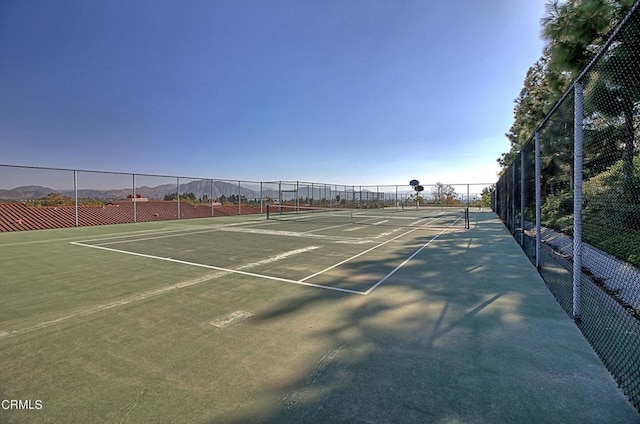 view of sport court with a mountain view