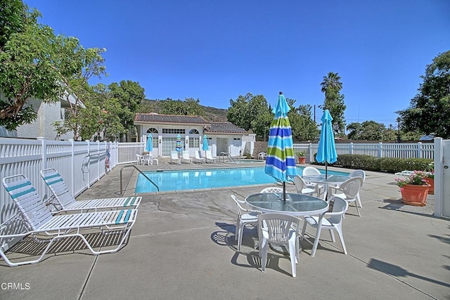 view of pool with an outdoor structure and a patio area