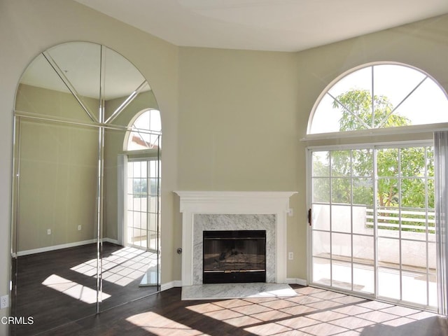 unfurnished living room with hardwood / wood-style flooring and a premium fireplace