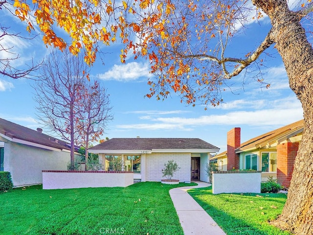 ranch-style house with a front lawn