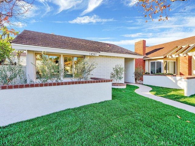 back of house with a lawn