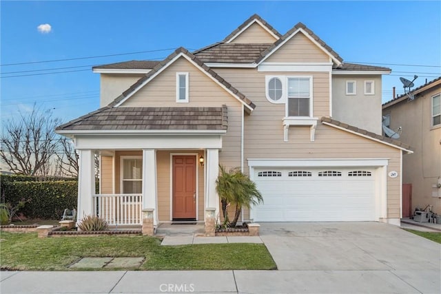 view of front of home with a porch, a garage, and a front yard