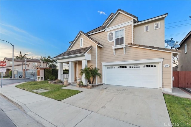 view of property with a garage and a front yard