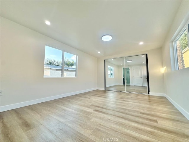 unfurnished bedroom with a closet and light hardwood / wood-style flooring