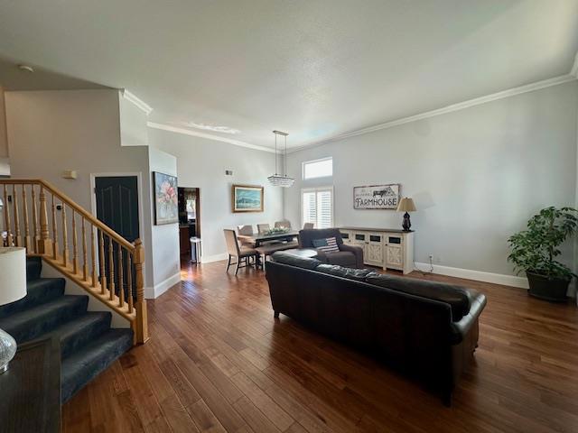 living room with dark wood-type flooring and ornamental molding