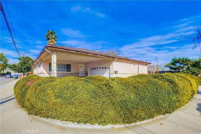 view of side of home featuring a garage