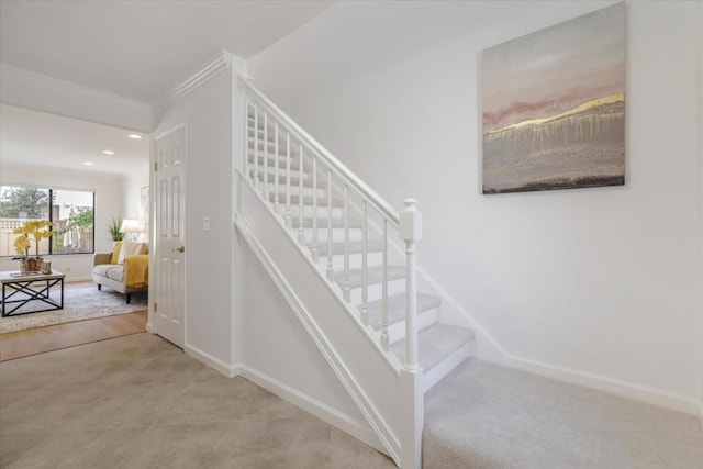 staircase featuring ornamental molding