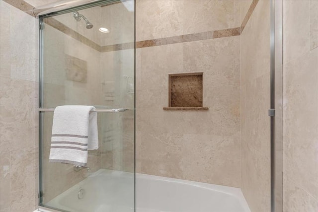 bathroom with shower / bath combination with glass door