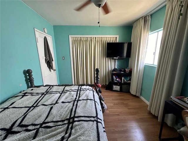 bedroom with hardwood / wood-style flooring and ceiling fan