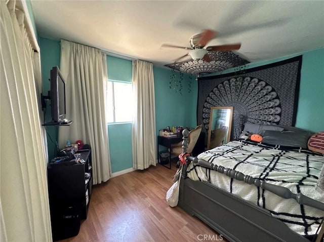 bedroom featuring wood-type flooring and ceiling fan