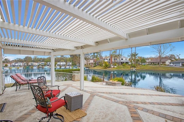 view of patio featuring a pergola and a water view