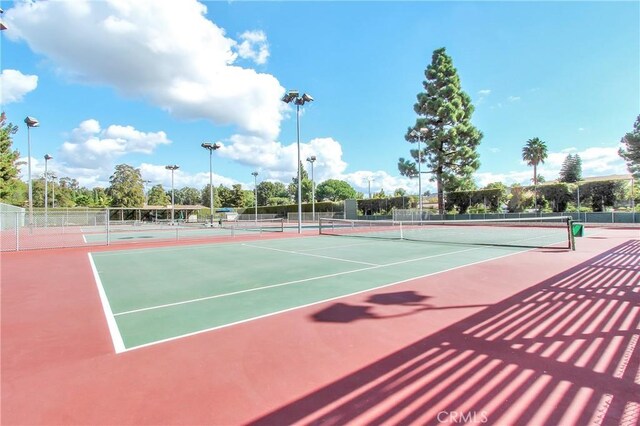 view of tennis court featuring fence