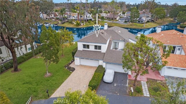 birds eye view of property with a residential view and a water view