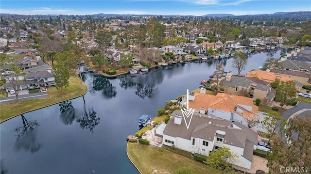 drone / aerial view featuring a water view and a residential view