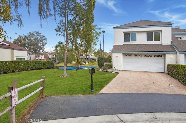 view of front of home with a garage and a front lawn