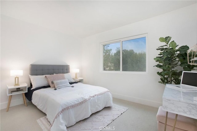 bedroom with light carpet and baseboards