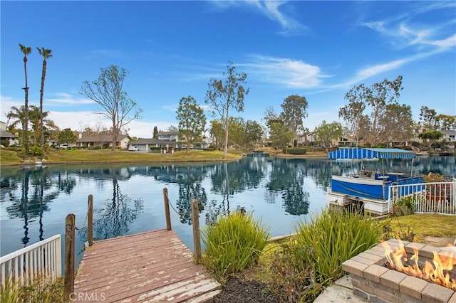 dock area featuring a water view and a fire pit