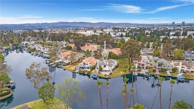 birds eye view of property with a water and mountain view