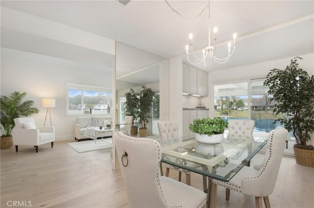 dining area featuring a chandelier and light wood-type flooring