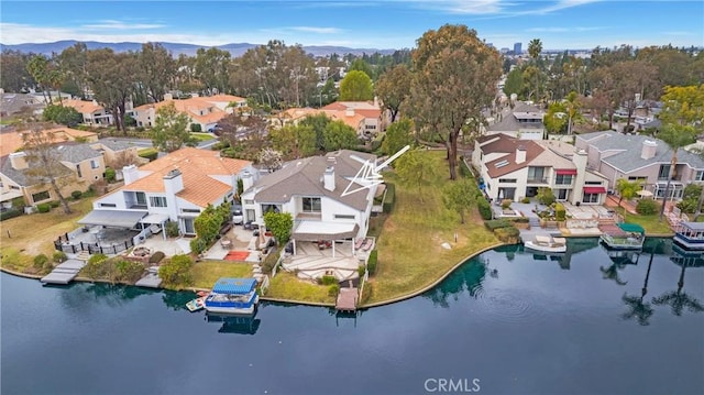 drone / aerial view featuring a water and mountain view