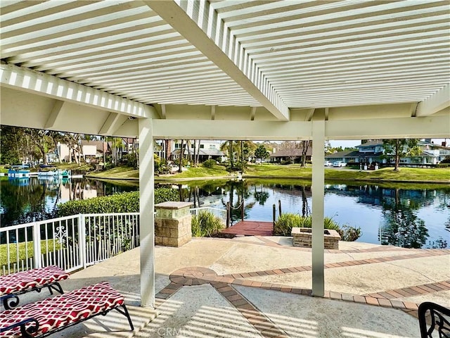 view of patio / terrace featuring a water view and a pergola