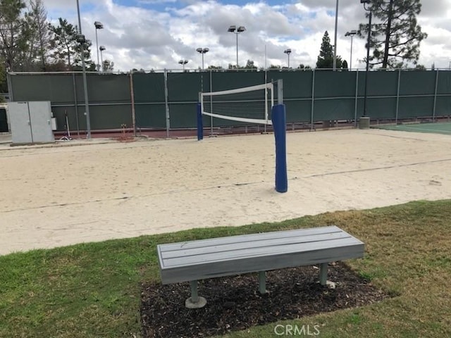 view of community with fence and volleyball court