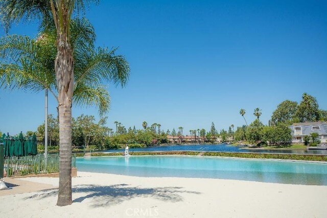 view of swimming pool with a water view