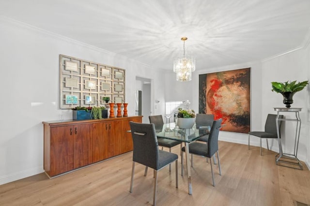 dining room with ornamental molding, a chandelier, and light wood-type flooring