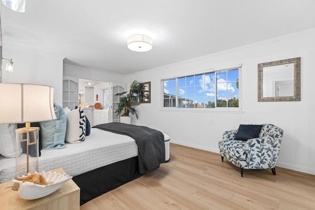 bedroom with crown molding and light hardwood / wood-style flooring