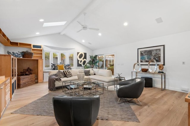 living room with a skylight, high vaulted ceiling, light hardwood / wood-style flooring, ceiling fan, and beam ceiling