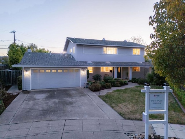 view of front of home featuring a garage and a yard