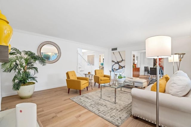 living room with hardwood / wood-style floors and crown molding