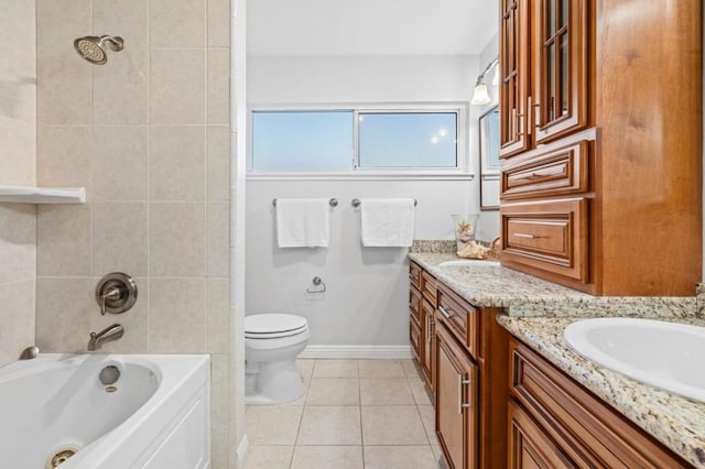 full bathroom featuring vanity, tile patterned flooring, tiled shower / bath combo, and toilet