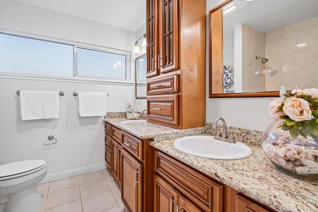 bathroom featuring tile patterned floors, vanity, toilet, and a shower