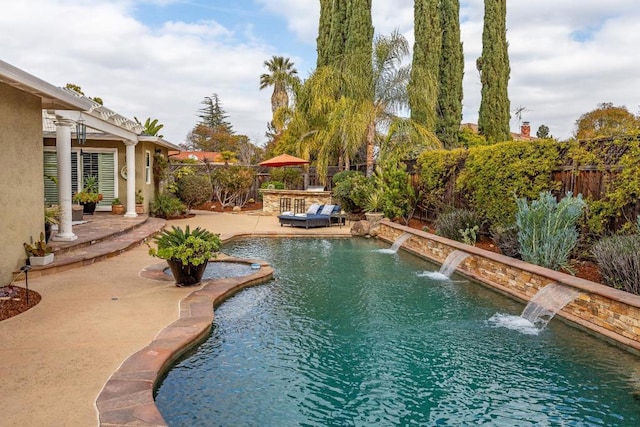 view of swimming pool with pool water feature and a patio