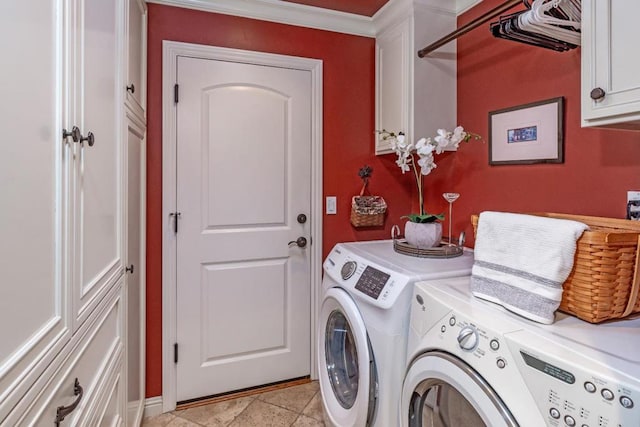 laundry area featuring washer and clothes dryer and cabinets