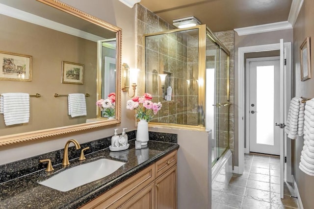 bathroom featuring vanity, crown molding, and bath / shower combo with glass door