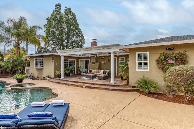 rear view of property featuring a swimming pool with hot tub, an outdoor hangout area, a patio area, and a pergola