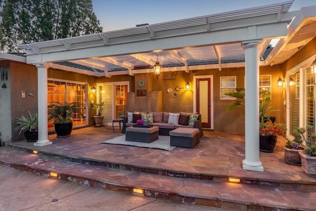 patio terrace at dusk featuring a pergola and an outdoor hangout area