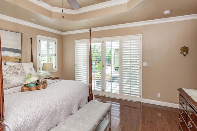 bedroom featuring dark wood-type flooring, crown molding, access to outside, a raised ceiling, and ceiling fan