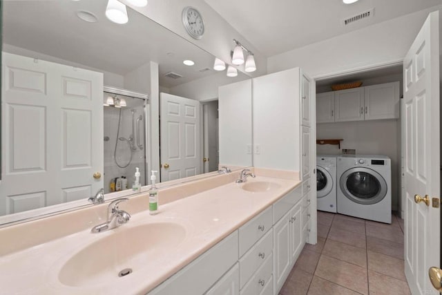 bathroom featuring vanity, tile patterned floors, washing machine and clothes dryer, and walk in shower