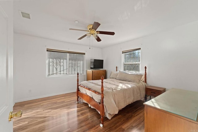 bedroom featuring ceiling fan and dark hardwood / wood-style floors