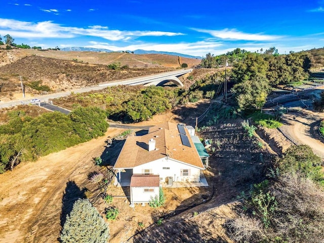 birds eye view of property featuring a mountain view