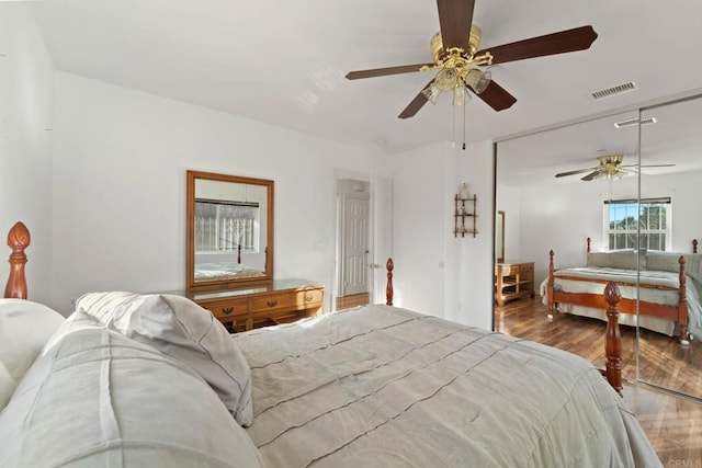 bedroom with ceiling fan, hardwood / wood-style floors, and a closet