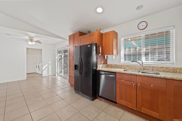 kitchen featuring sink, plenty of natural light, separate washer and dryer, black fridge with ice dispenser, and stainless steel dishwasher