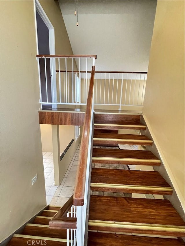 staircase featuring tile patterned floors